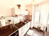 a kitchen with white cabinets and a sink and a window at EL DREAM - WiFi NetFlix Centre-ville in Lisieux