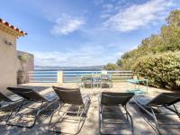 a patio with chairs and tables and a view of the water at Apartment la Rainette by Interhome in La Madrague