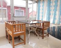 een eetkamer met een glazen tafel en 2 stoelen bij Kopa Ville Resort in Shānti Niketan