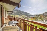a balcony with a table and chairs and a view at Studio cabine Le Charvet in Le Grand-Bornand