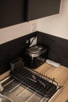 a kitchen counter with a stove and a toaster oven at LE MONDRIAN - Hôtel de ville - Confort - Paisible - Wi-Fi in Saint-Étienne