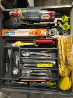 a drawer filled with cooking utensils and other items at Studio Lilouna avec parking privé in Le Tréport