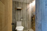 a bathroom with a toilet and a glass shower at Hualien Wow Hostel in Hualien City