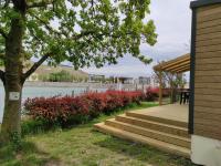 a porch with stairs next to a lake at Camping le Rhône in Tournon-sur-Rhône