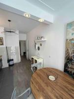 a dining room with a wooden table in a room at Appartement atypique et original in Nice