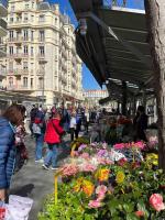 a group of people walking around a market with flowers at Appartement atypique et original in Nice