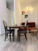 a table and chairs in a living room with a couch at Appartement atypique et original in Nice