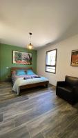 a bedroom with a bed and a chair in it at LES ROCHES DE BAUDISSET in Saint-Paul-en-Forêt