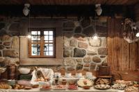 een keuken met een tafel vol eten en een stenen muur bij Hotel Los Andes in Castello di Fiemme