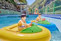 two young boys riding on an inflatables in a swimming pool at Uni-Resort Ku-Kuan in Heping