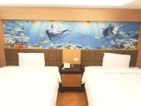 a room with two beds and a mural of dolphins at JinShan Sakura Bay Hot Spring Hotel in Jinshan