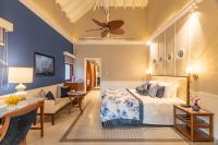 a bedroom with a bed and a living room at Taj Holiday Village Resort & Spa, Goa in Candolim