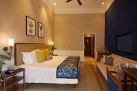 a hotel room with a bed and a couch at Taj Holiday Village Resort & Spa, Goa in Candolim