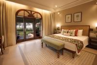 a bedroom with a large bed and a large window at Taj Holiday Village Resort & Spa, Goa in Candolim