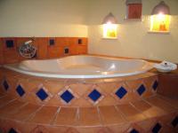 a large tub in a bathroom with two lights at Ecotel Quinta Regia in Valladolid