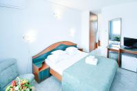 a hotel room with a bed and a television at COMPLEX TISMANA 3* ALL INCLUSIVE in Jupiter
