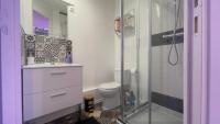 a bathroom with a toilet and a glass shower at Le cocon du Nil jolie studio in Douai