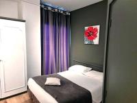 a bedroom with a bed with a red flower in a mirror at Hôtel Restaurant Villa Riva in Veyrier-du-Lac