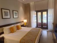 a hotel room with a large bed and a window at Taj Holiday Village Resort & Spa, Goa in Candolim