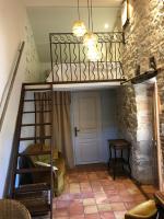 a room with a bunk bed and a ladder at Le pigeonnier du beffroi in Bruniquel