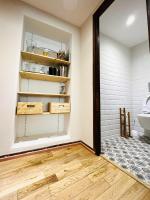 a bathroom with a door open to a bathroom with wood floors at Le Georges V in Alzonne