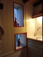 a bathroom with a fishtank with a jug in a mirror at La maison du pech in Monteils