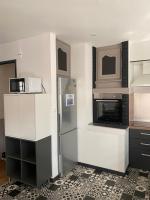 a kitchen with a refrigerator and a microwave at Superbe appartement F4 au cœur de Malo-les-bains in Dunkerque