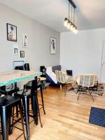 a living room with chairs and a table and a couch at Lumineux T5 en centre ville in Angoulême