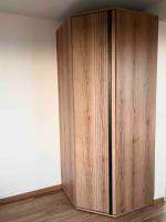 a wooden cabinet in the corner of a room at Studio côté plage tout équipé vue sur le Canigou in Canet-en-Roussillon
