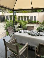 a table and chairs under an umbrella on a patio at Le Jardin Cathedrale in Chartres