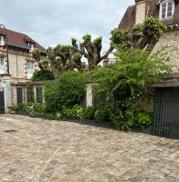 a house with a fence and a tree at Le Jardin Cathedrale in Chartres