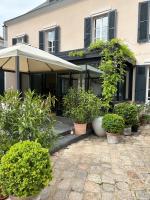 a house with plants in pots in front of it at Le Jardin Cathedrale in Chartres