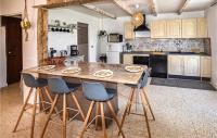 a kitchen with a large wooden table and chairs at Amazing Home In Lapalud With Outdoor Swimming Pool, Wifi And Private Swimming Pool in Lapalud