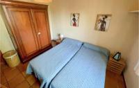 a bedroom with a blue bed and two pictures on the wall at Amazing Home In Mazan With Wifi in Mazan