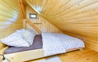 a room with a bed in a wooden cabin at Beautiful Home In Kraljev Vrh With Wifi in Kraljev Vrh