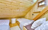 a log cabin with two beds in a room at Beautiful Home In Kraljev Vrh With Wifi in Kraljev Vrh
