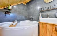 a bathroom with a large white tub and a sink at Beautiful Home In Kraljev Vrh With Wifi in Kraljev Vrh