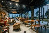 Hippie Home Mộc Châu في موك تشاو: مطعم به طاولات وكراسي ونوافذ