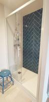 a shower with a blue tile wall in a bathroom at Grand Appartement Familial, Tours Centre, Parking in Tours