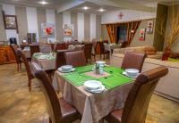 a restaurant with tables and chairs in a room at Khoi-Khoi Guesthouse in Otavi