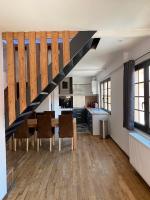 a kitchen with a dining table and a staircase at Superbe appartement F4 au cœur de Malo-les-bains in Dunkerque