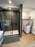 a glass shower in a bathroom with a sink at Superbe appartement F4 au cœur de Malo-les-bains in Dunkerque