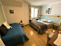 a bedroom with a large bed and a window at CHAMBRES D&#39;HOTES 2 à 4p ou GITE DE GROUPE 15p, 7 ch, 6 sdb, parc et salle de réception in Villeneuve-de-Berg
