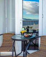 a table and chairs on a balcony with a view at Apartman Tramontana in Opatija