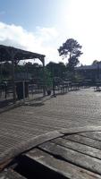 a group of tables and benches in a park at En bord d'eau - charmant Mobil-home climatisé - Cap ferret in Lège-Cap-Ferret