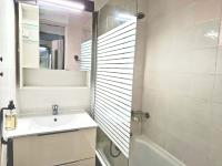a white bathroom with a sink and a shower at Studio mezzanine entier à 5min de la plage et de St tropez in Cogolin