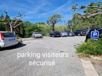a parking lot with cars parked in it at Studio mezzanine entier à 5min de la plage et de St tropez in Cogolin
