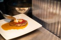 a white plate with a piece of food on a table at ANC Resort in Caloura