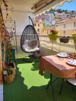 a balcony with a hammock and a table and a swing at Une invitation à la détente in Nice