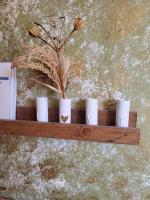 a wooden shelf with white cups and flowers on it at Une invitation à la détente in Nice
